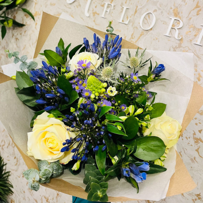 Serene Blue Serenity - A peaceful and calming arrangement of blue and white blooms, accented with lush greenery.